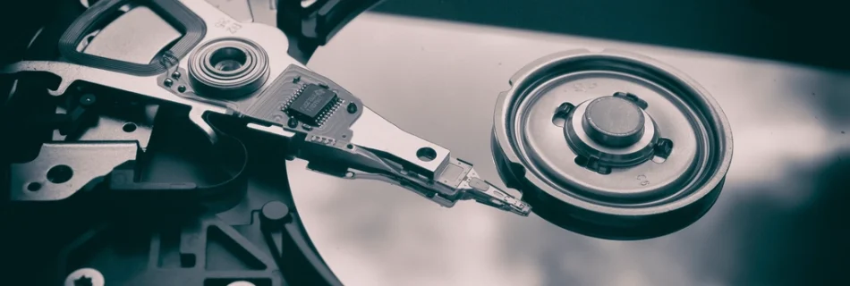 The open platter and read arm of a hard disk drive