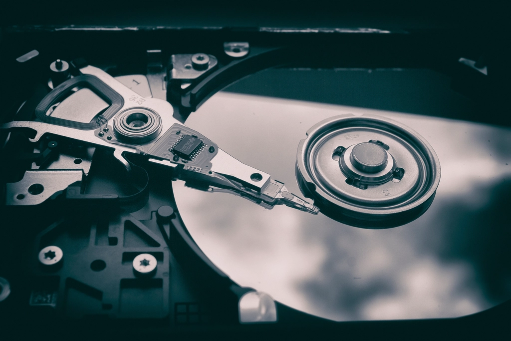 The open platter and read arm of a hard disk drive